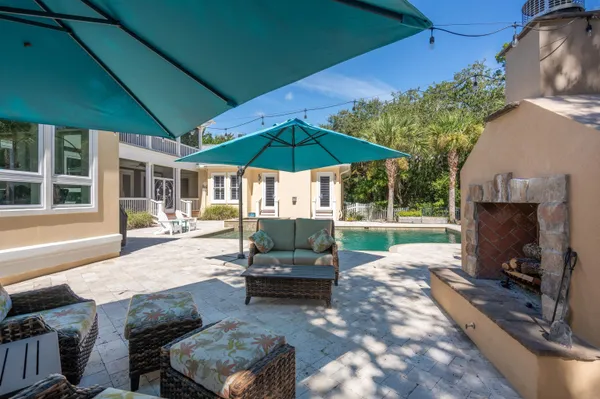 a front view of a house with swimming pool having outdoor seating