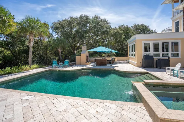 an aerial view of a house with swimming pool and garden