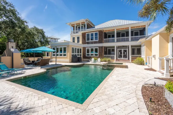 an aerial view of house with yard and mountain view in back