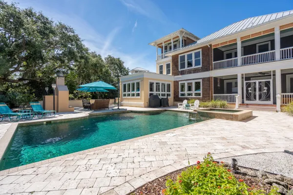 a view of a house with backyard sitting area and garden