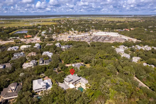 a living room with furniture a dining table and a chandelier
