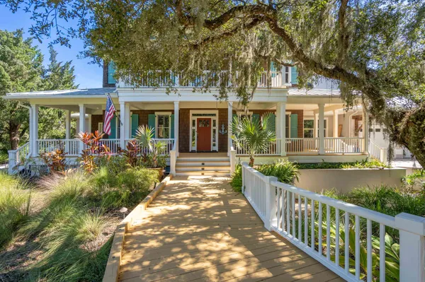 a view of a hallway with wooden floor and windows