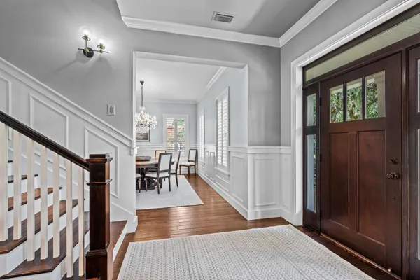a bedroom with a bed and a table with wooden floor