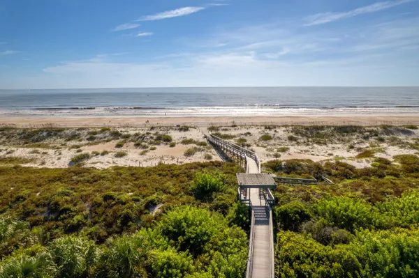 a view of a street with a building and trees in the background
