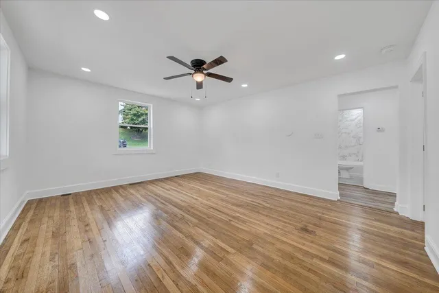 wooden floor in an empty room with a window