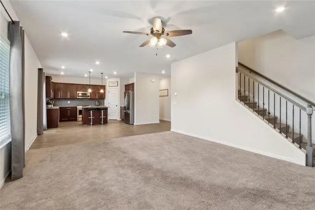 a kitchen with stainless steel appliances granite countertop a refrigerator and a stove