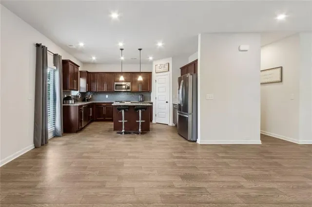 a kitchen with a sink a counter top space appliances and cabinets
