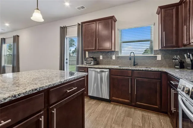 a kitchen with a sink and a refrigerator