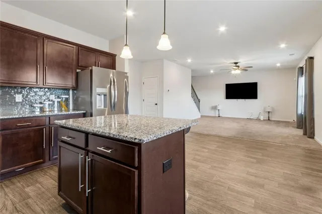 a kitchen with stainless steel appliances granite countertop a sink stove and microwave