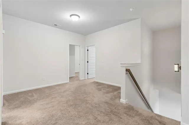 a bedroom with a bed and a flat tv screen on dresser