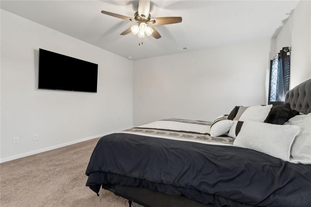 1130 Lyndhurst Lane Bethlehem, GA 30620 - Photo 27 of 46 a bedroom with a bed and a flat screen tv