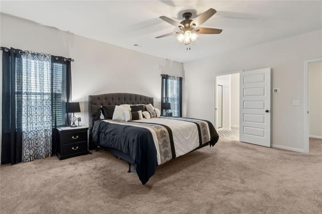 1130 Lyndhurst Lane Bethlehem, GA 30620 - Photo 28 of 46 a bedroom with a bed and a chandelier