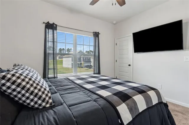 a bedroom with a bed and window