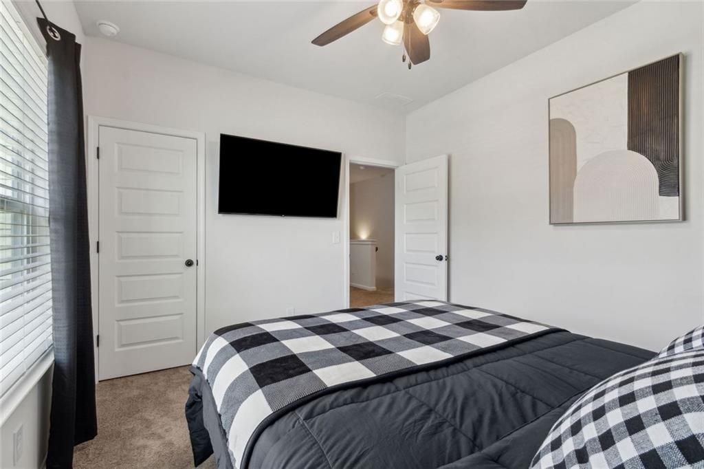 1130 Lyndhurst Lane Bethlehem, GA 30620 - Photo 36 of 46 a bedroom with a bed and a flat screen tv