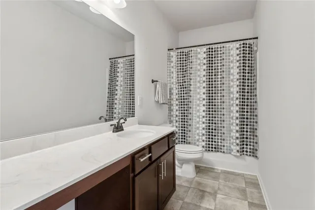 a bedroom with a bed and a flat tv screen on a dresser