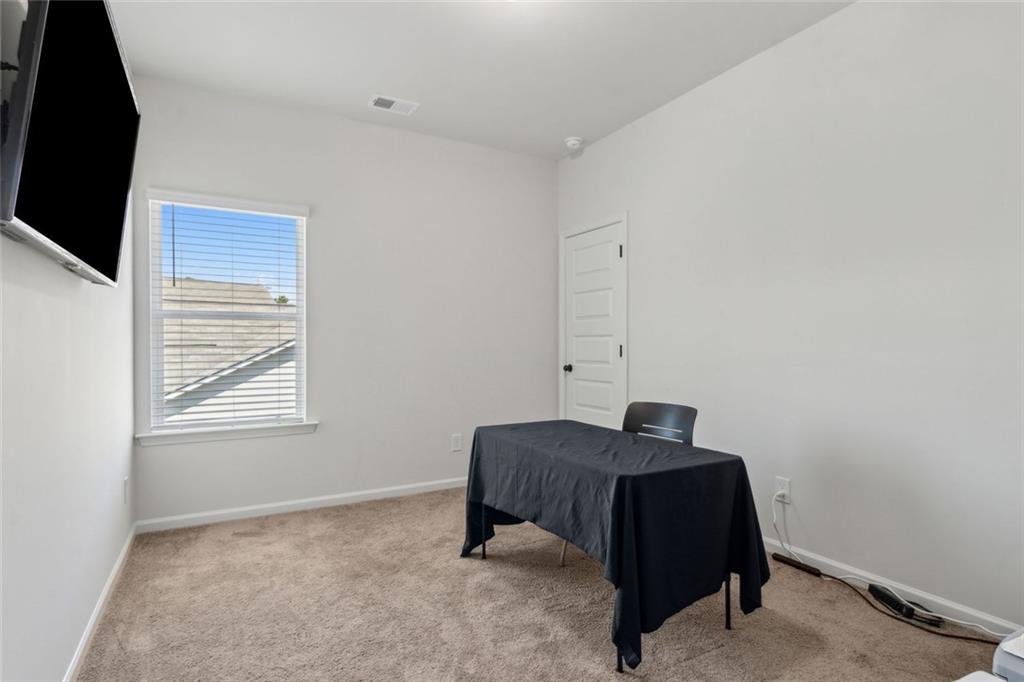 1130 Lyndhurst Lane Bethlehem, GA 30620 - Photo 38 of 46 a bedroom with a bed and a flat tv screen on a dresser