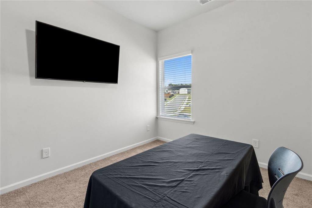 1130 Lyndhurst Lane Bethlehem, GA 30620 - Photo 40 of 46 a bedroom with a bed and a flat screen tv