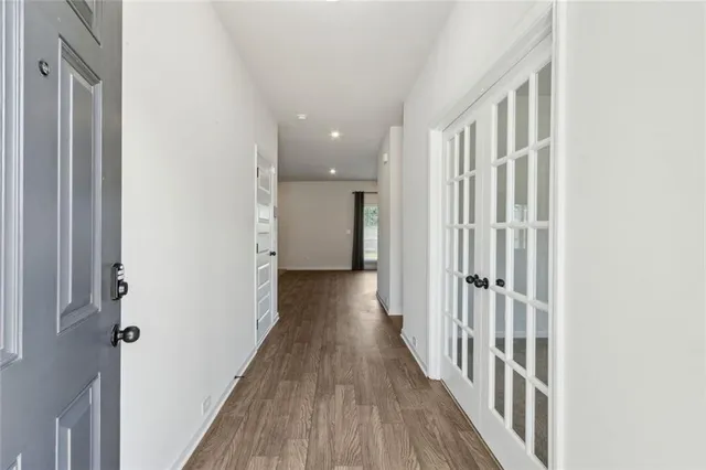 a view of a hallway with wooden floor