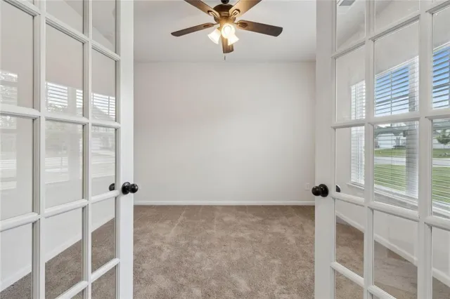 an empty room with windows and closet