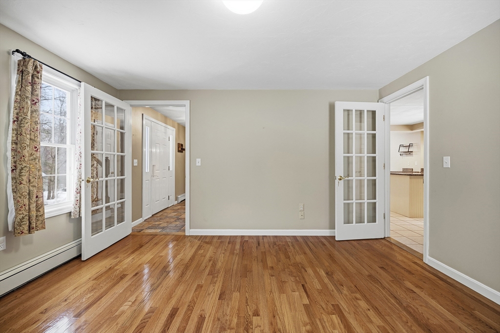 86 Hunter Road Uxbridge, MA 01569 - Photo 11 of 34 wooden floor in an empty room with a window