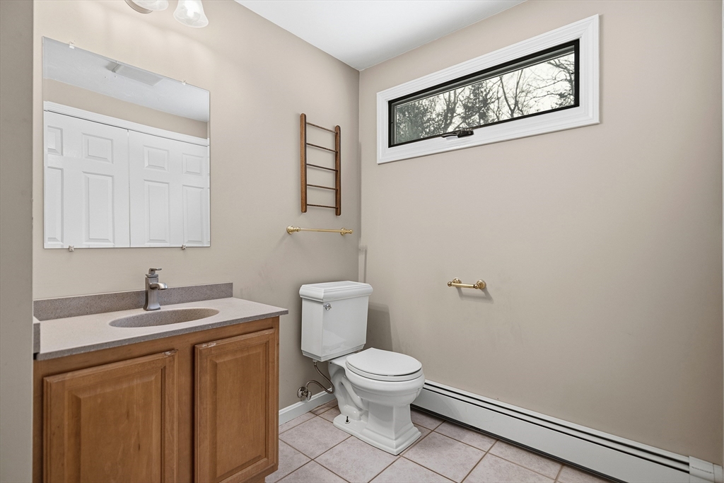 86 Hunter Road Uxbridge, MA 01569 - Photo 12 of 34 a white toilet sitting next to a bathroom sink