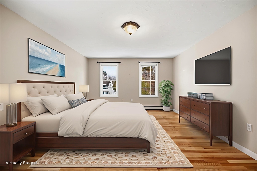 86 Hunter Road Uxbridge, MA 01569 - Photo 14 of 34 a bedroom with a bed and a flat screen television