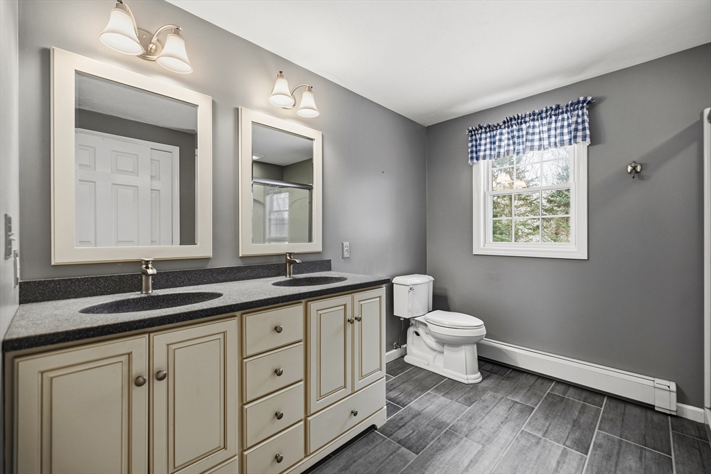 86 Hunter Road Uxbridge, MA 01569 - Photo 16 of 34 a bathroom with a toilet a sink and mirror