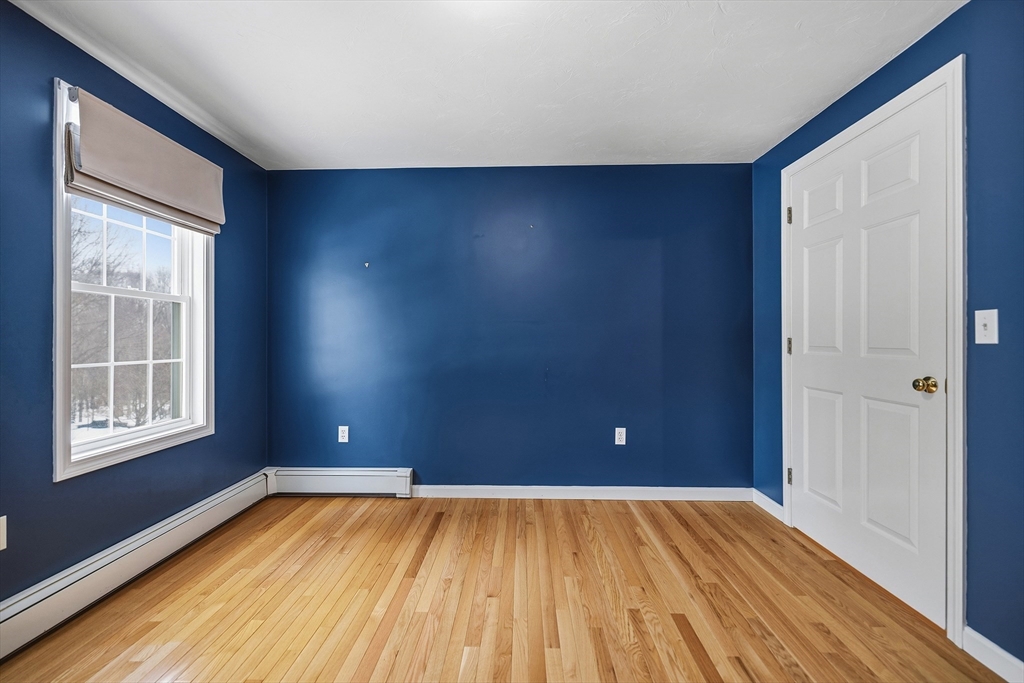 86 Hunter Road Uxbridge, MA 01569 - Photo 19 of 34 a view of empty room with wooden floor and fan