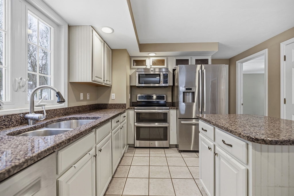 86 Hunter Road Uxbridge, MA 01569 - Photo 2 of 34 a kitchen with stainless steel appliances granite countertop a sink and a refrigerator