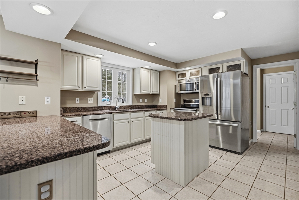 86 Hunter Road Uxbridge, MA 01569 - Photo 3 of 34 a kitchen with stainless steel appliances granite countertop a refrigerator sink and stove