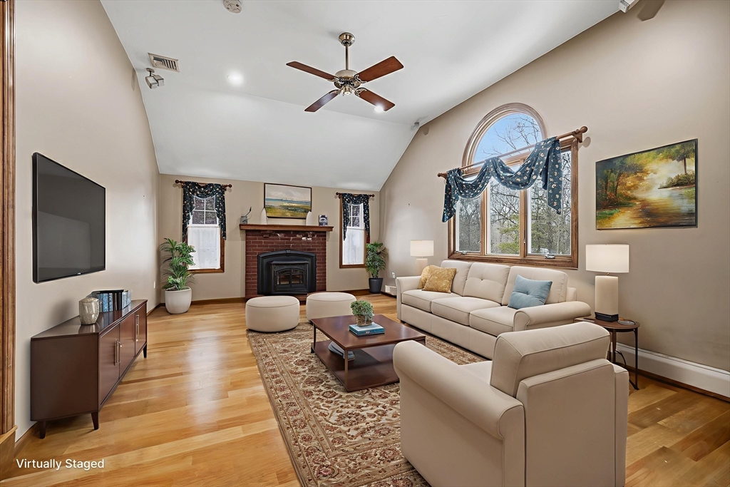 86 Hunter Road Uxbridge, MA 01569 - Photo 7 of 34 a living room with furniture a fireplace and a flat screen tv