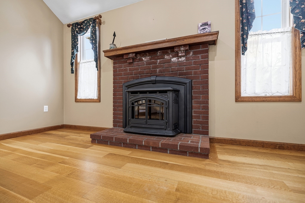 86 Hunter Road Uxbridge, MA 01569 - Photo 8 of 34 a view of an empty room with a fireplace and a window