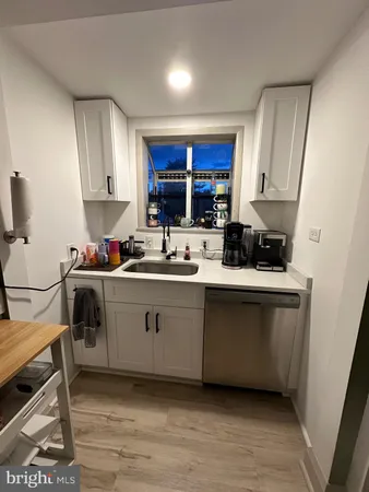 a kitchen with a sink cabinets and window