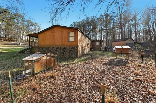 a backyard of a house with table and chairs