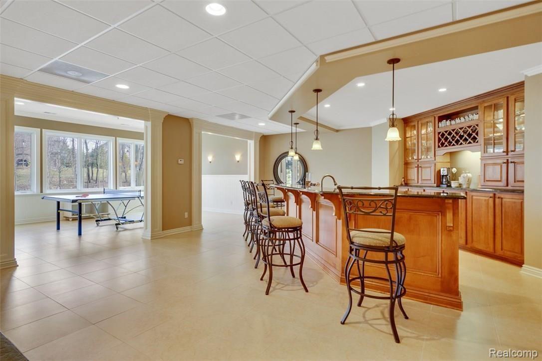 4657 Fawn Hill Court Rochester, MI 48306 - Photo 63 of 79 The Lower Level Bar has been Handcrafted of Maple and Boasts Gorgeous Granite as well