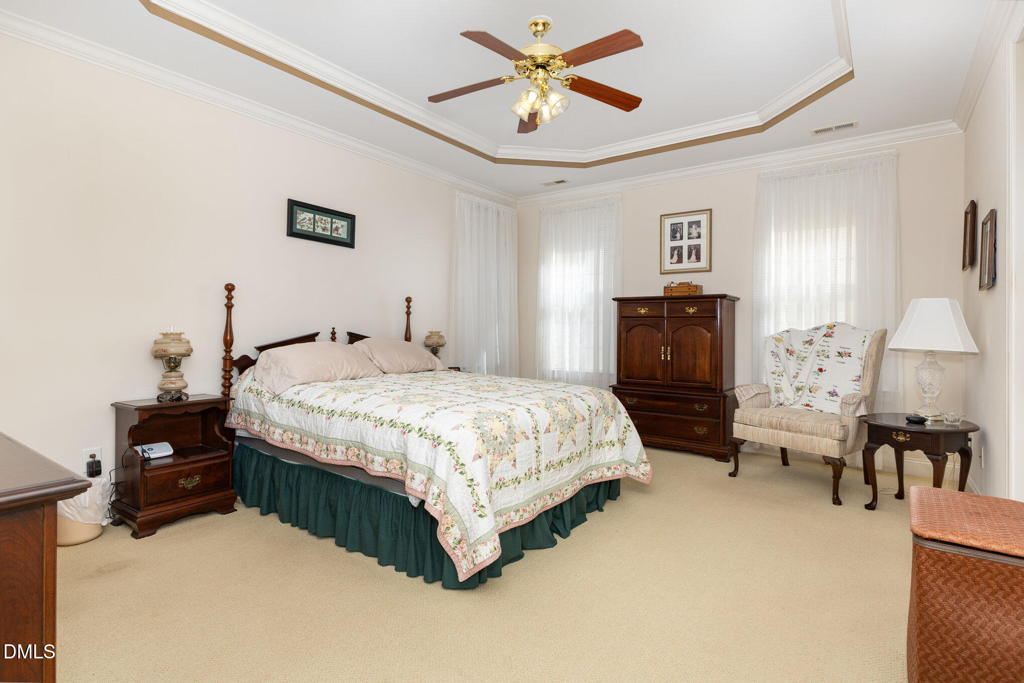 505 Easy Wind Lane Garner, NC 27529 - Photo 14 of 40 a bedroom with a bed and dresser with chair