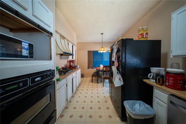 a kitchen with stainless steel appliances a stove a sink and a refrigerator