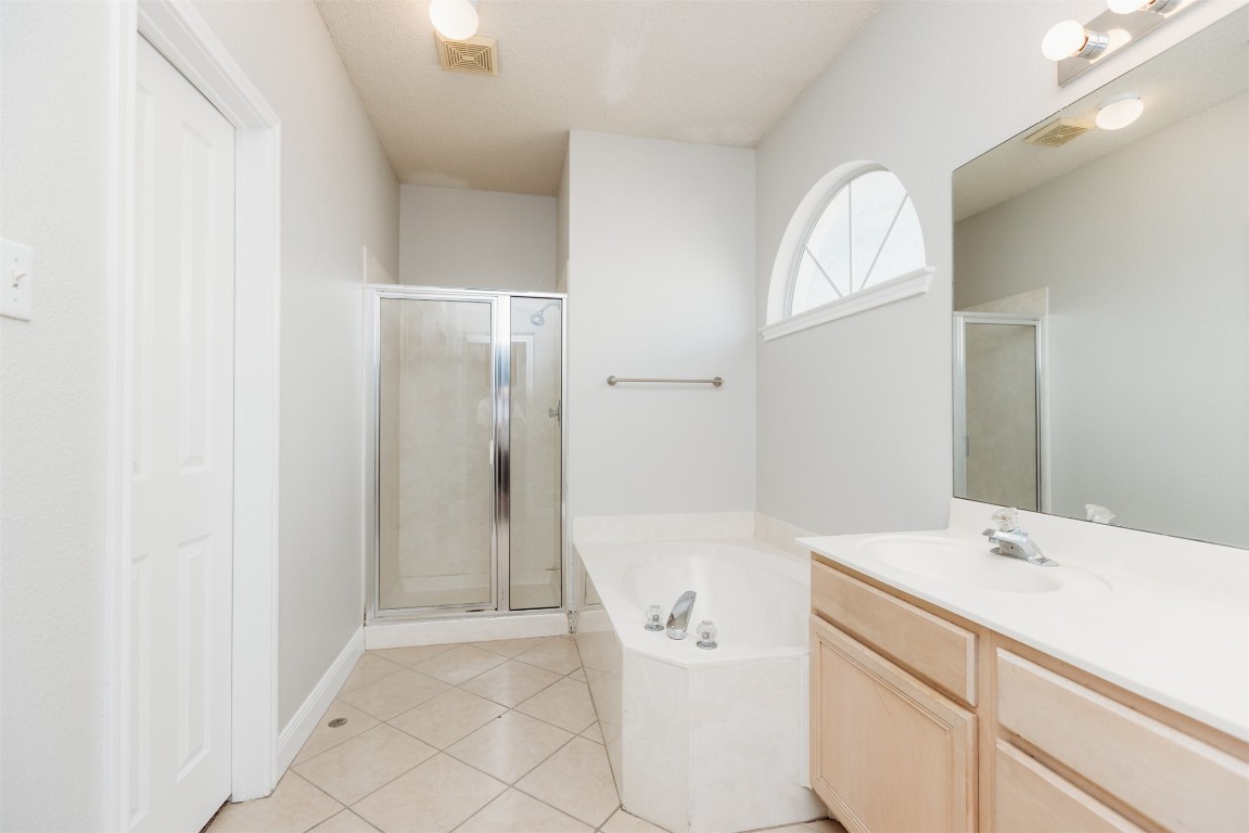 1506 Freestone Drive Pflugerville, TX 78660 - Photo 12 of 20 a bathroom with a sink a toilet and shower