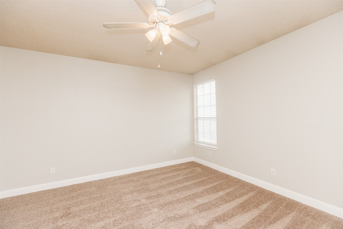 1506 Freestone Drive Pflugerville, TX 78660 - Photo 18 of 20 an empty room with a window and a ceiling fan
