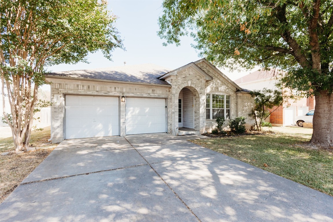 1506 Freestone Drive Pflugerville, TX 78660 - Photo 2 of 20 a front view of a house with a yard and garage