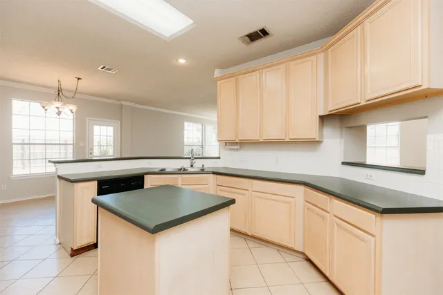 a kitchen that has a sink a stove counter top space and cabinets