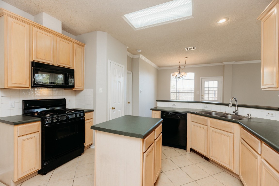 1506 Freestone Drive Pflugerville, TX 78660 - Photo 10 of 20 a kitchen with a sink stove top oven and microwave