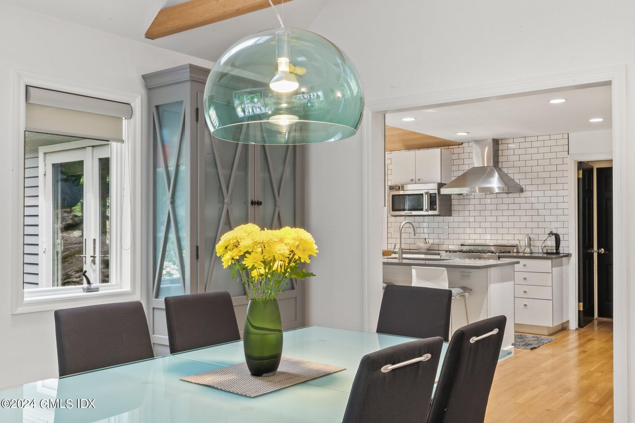 300 Orchard Street Greenwich, CT 06830 - Photo 11 of 40 a dining room filled chandelier and kitchen view