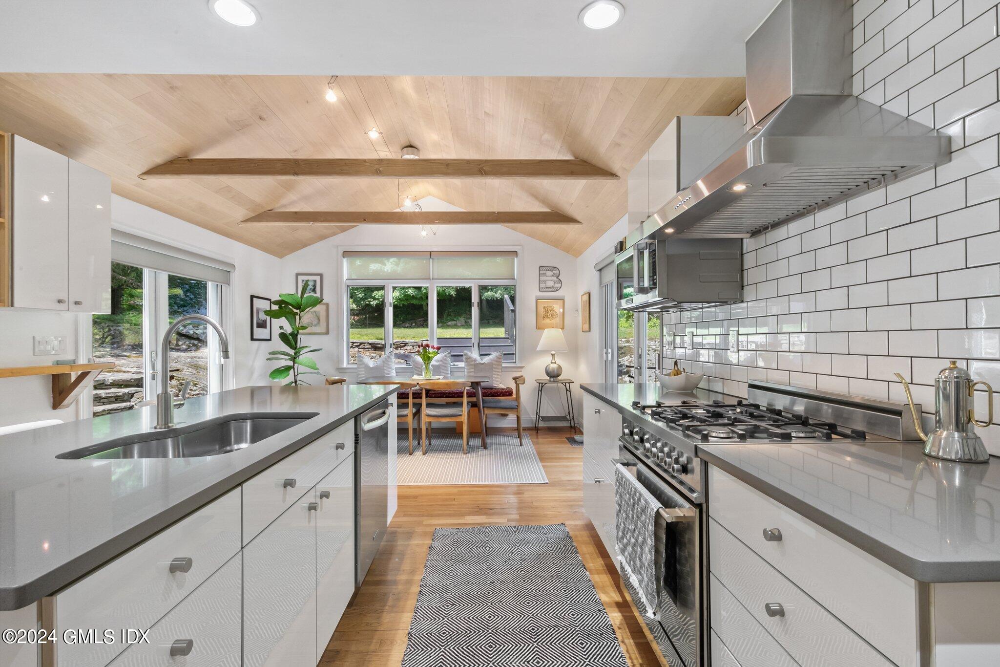 300 Orchard Street Greenwich, CT 06830 - Photo 13 of 40 a kitchen with sink stove and cabinets