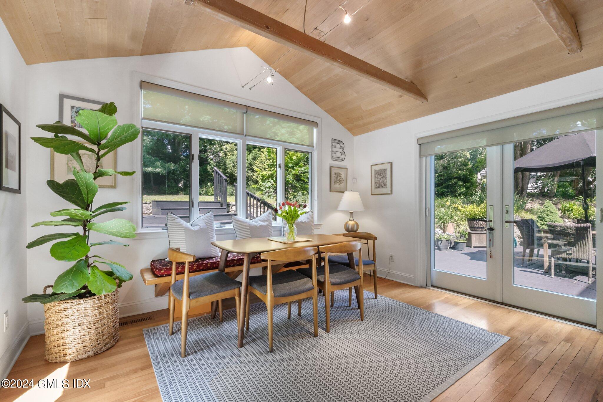 300 Orchard Street Greenwich, CT 06830 - Photo 16 of 40 a dining room with furniture window and wooden floor