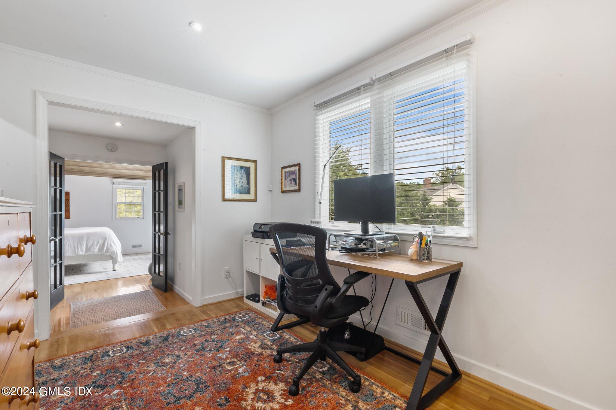 300 Orchard Street Greenwich, CT 06830 - Photo 17 of 40 a workspace with furniture and a window