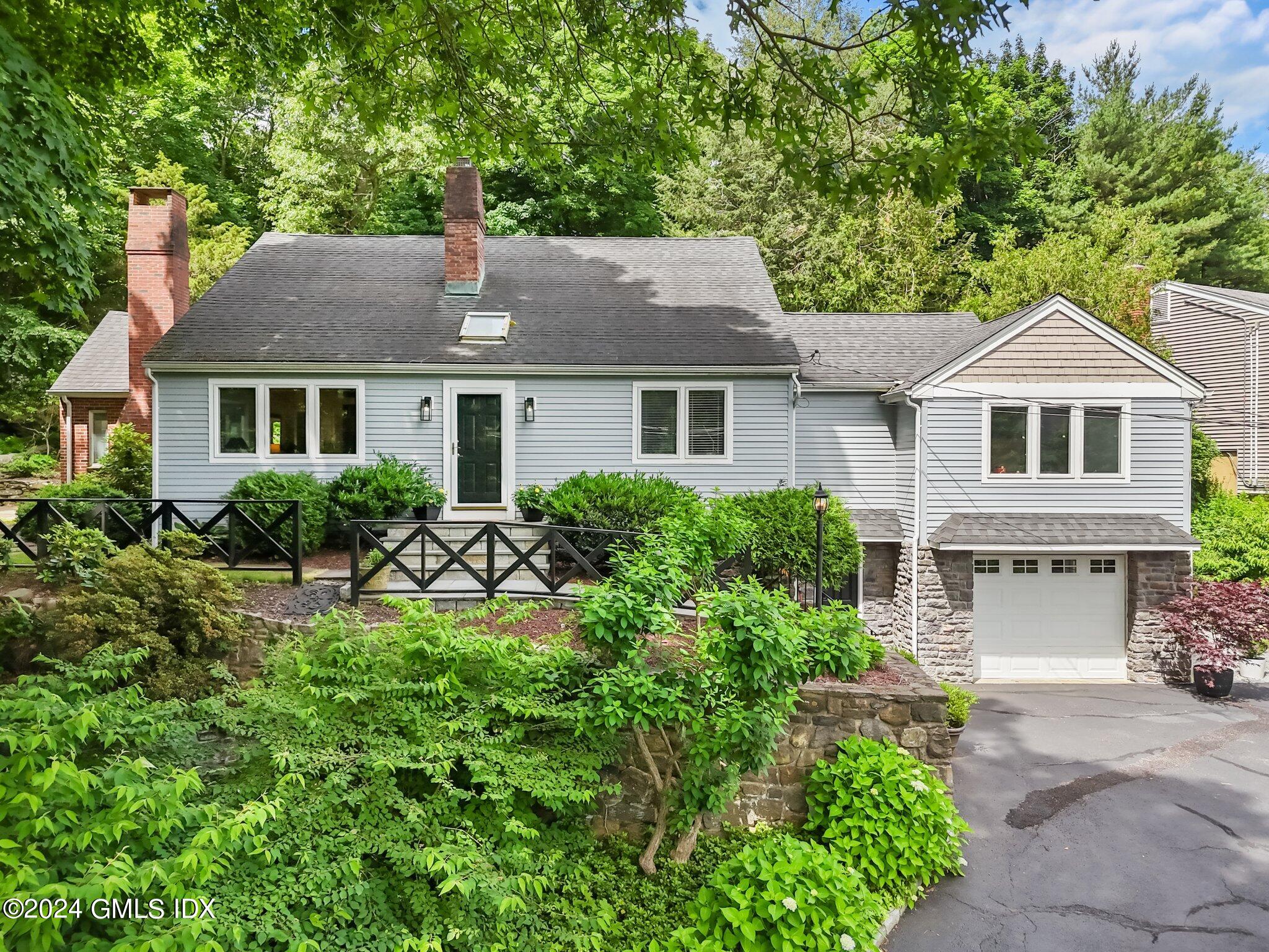 300 Orchard Street Greenwich, CT 06830 - Photo 2 of 40 a house view with a garden space
