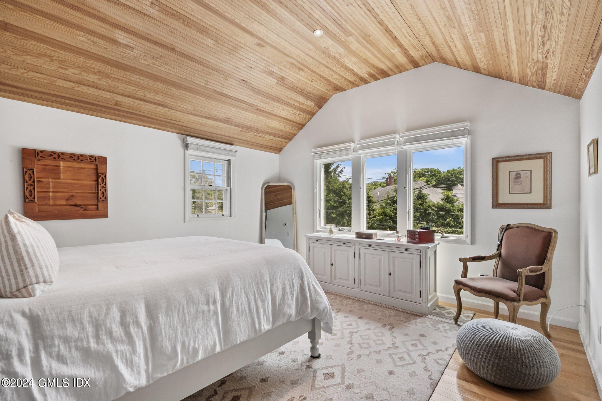 300 Orchard Street Greenwich, CT 06830 - Photo 21 of 40 a bedroom with furniture and a large window