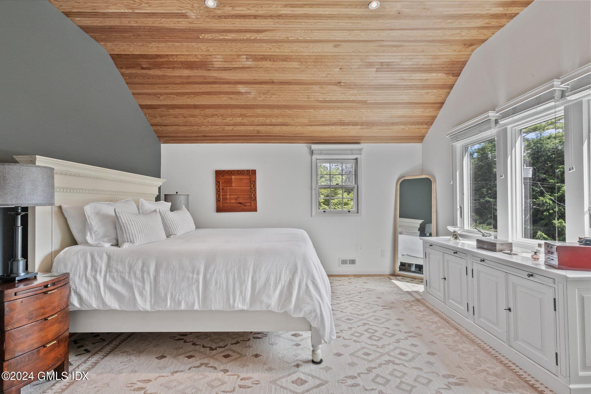 300 Orchard Street Greenwich, CT 06830 - Photo 22 of 40 a bedroom with a bed and a large window