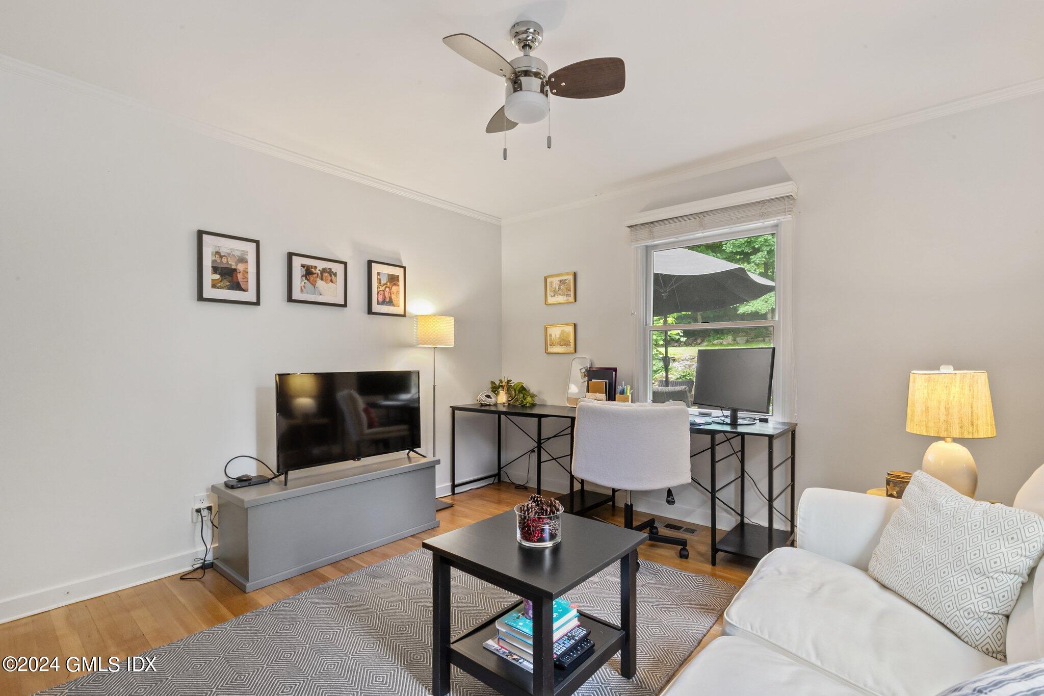300 Orchard Street Greenwich, CT 06830 - Photo 26 of 40 a living room with furniture and a fireplace